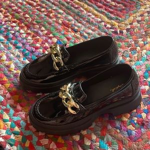 Shiny black chunky flats